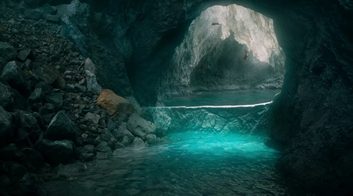 A sea cave near Taormina glowing luminous turquoise, seen from the water at the mouth of the grotto