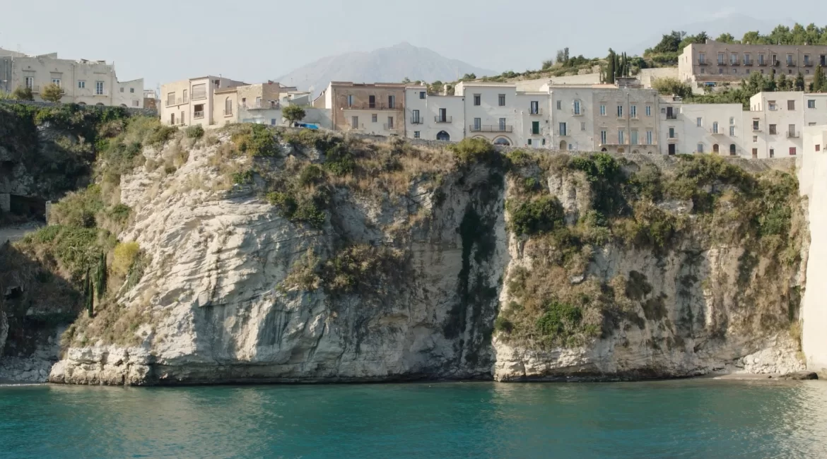 Taormina by boat: the town and its cliffs seen from the sea below