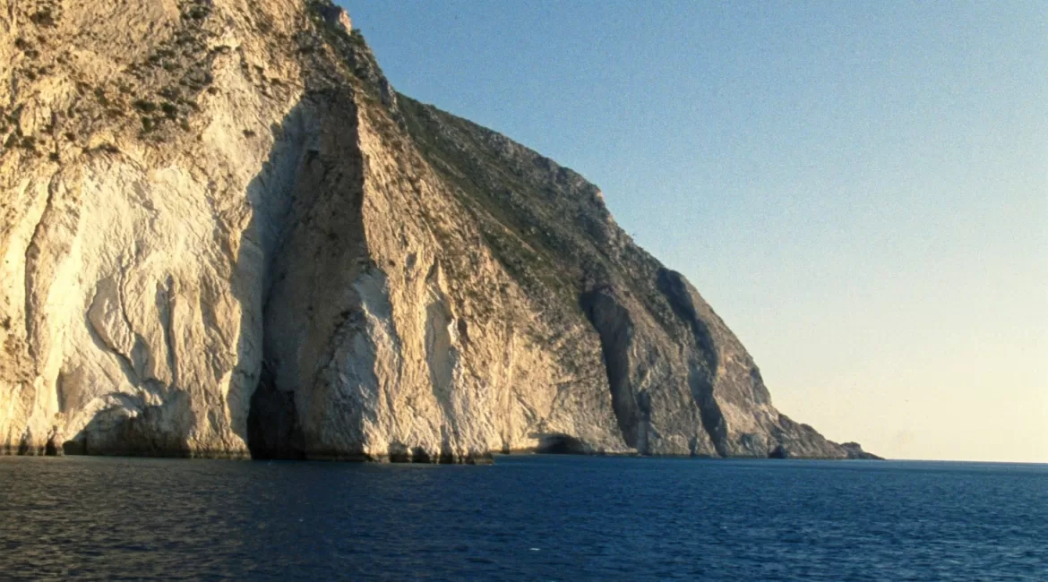 Photographing the Taormina coast by boat: golden evening light on the cliffs
