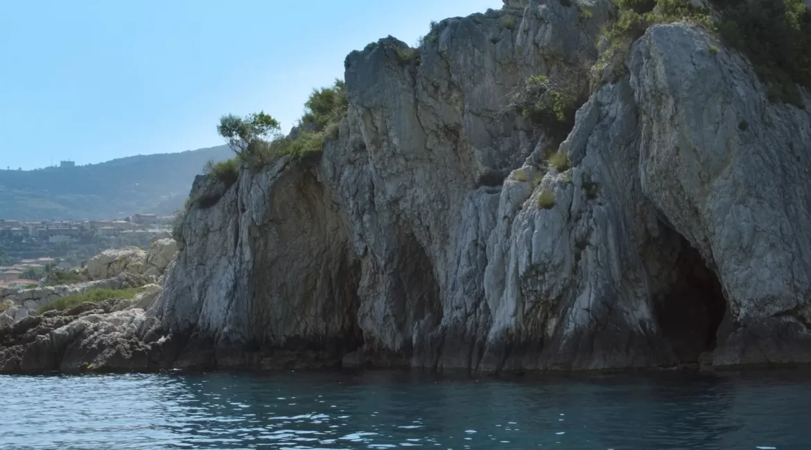A 2-hour boat excursion in Taormina: the cliffs and sea cave openings below the town seen from the water