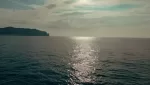Taormina boat tour weather: light breeze and small waves on the Ionian sea below the Taormina cliffs