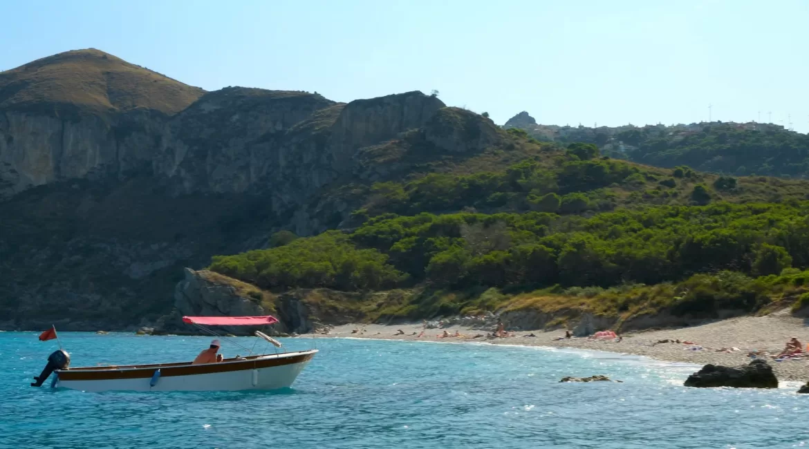 Taormina without a car: the cable car line and the coast road above Mazzaro bay seen from the sea